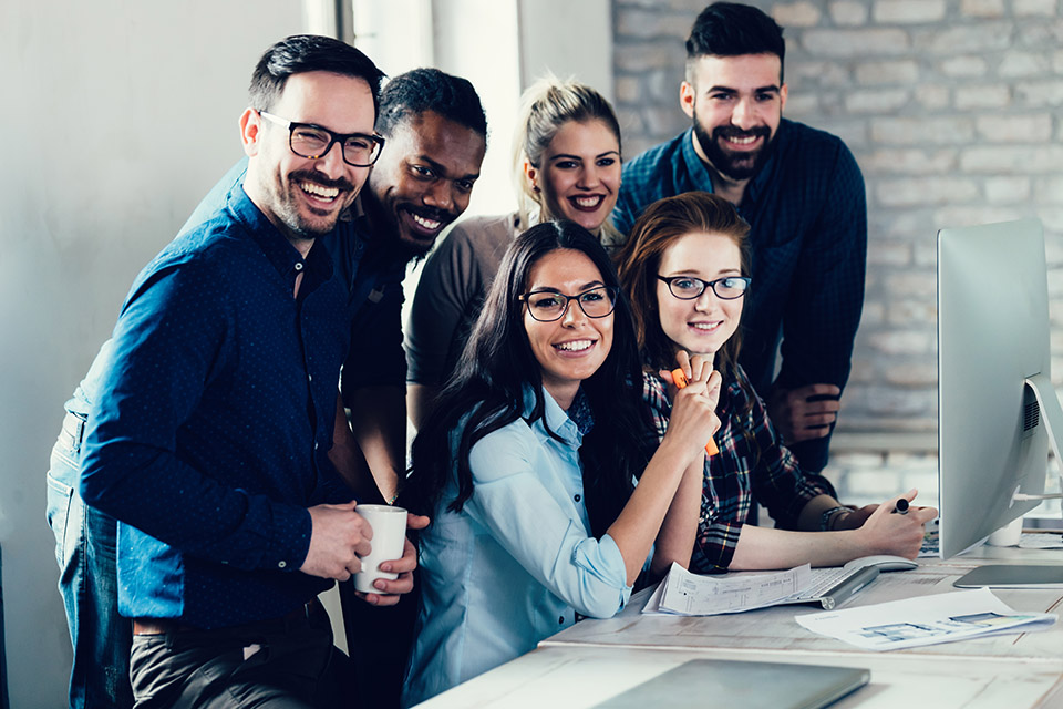 Bild von Männern und Frauen, die in einem modernen Büro zusammenarbeiten.